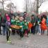 Eine Gruppe von Erwachsenen und Kindern versammelt sich im Freien bei einem Gemeinschaftsevent.